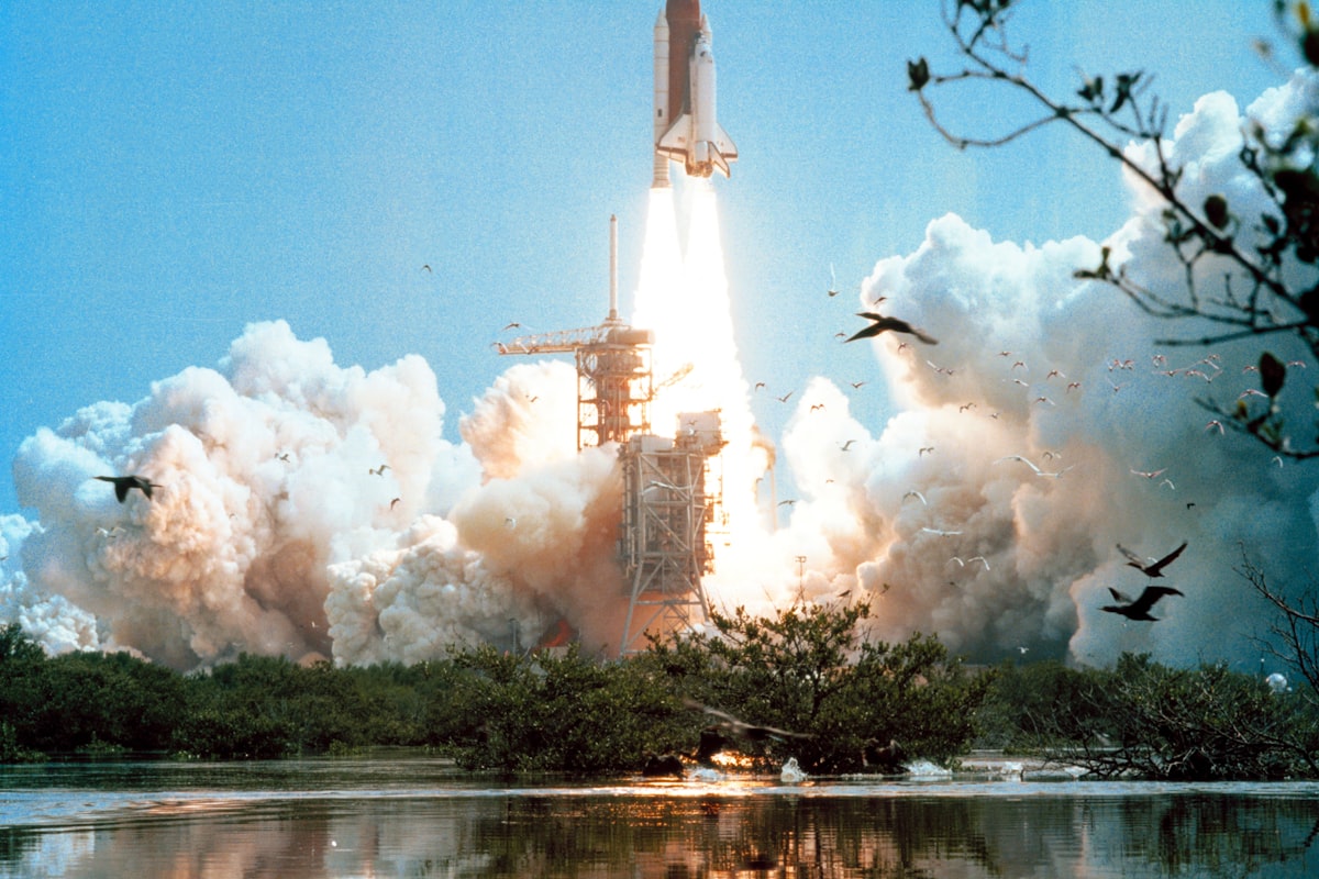 Space shuttle ascending on a column of exhaust
